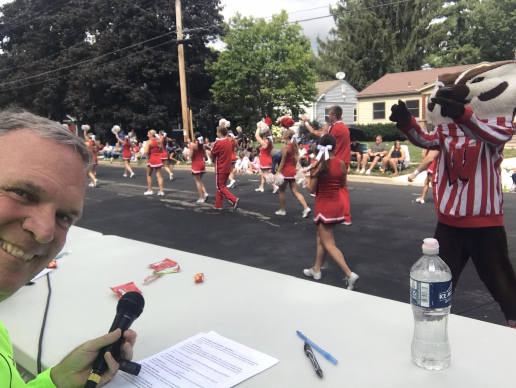 GNF Parade emcee Perry Hibner greets Bucky Badger
